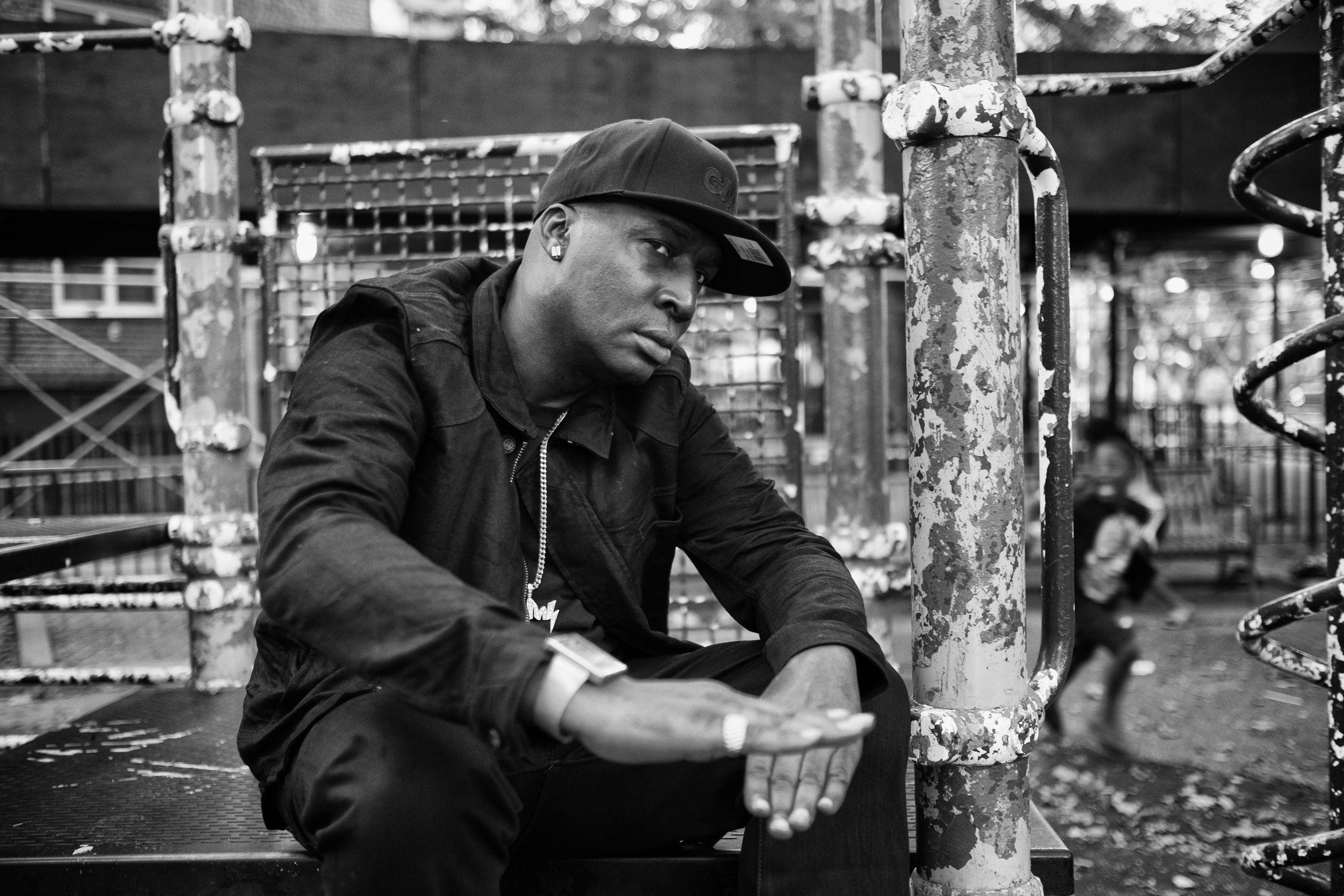 Grandmaster Flash seated in an industrial setting